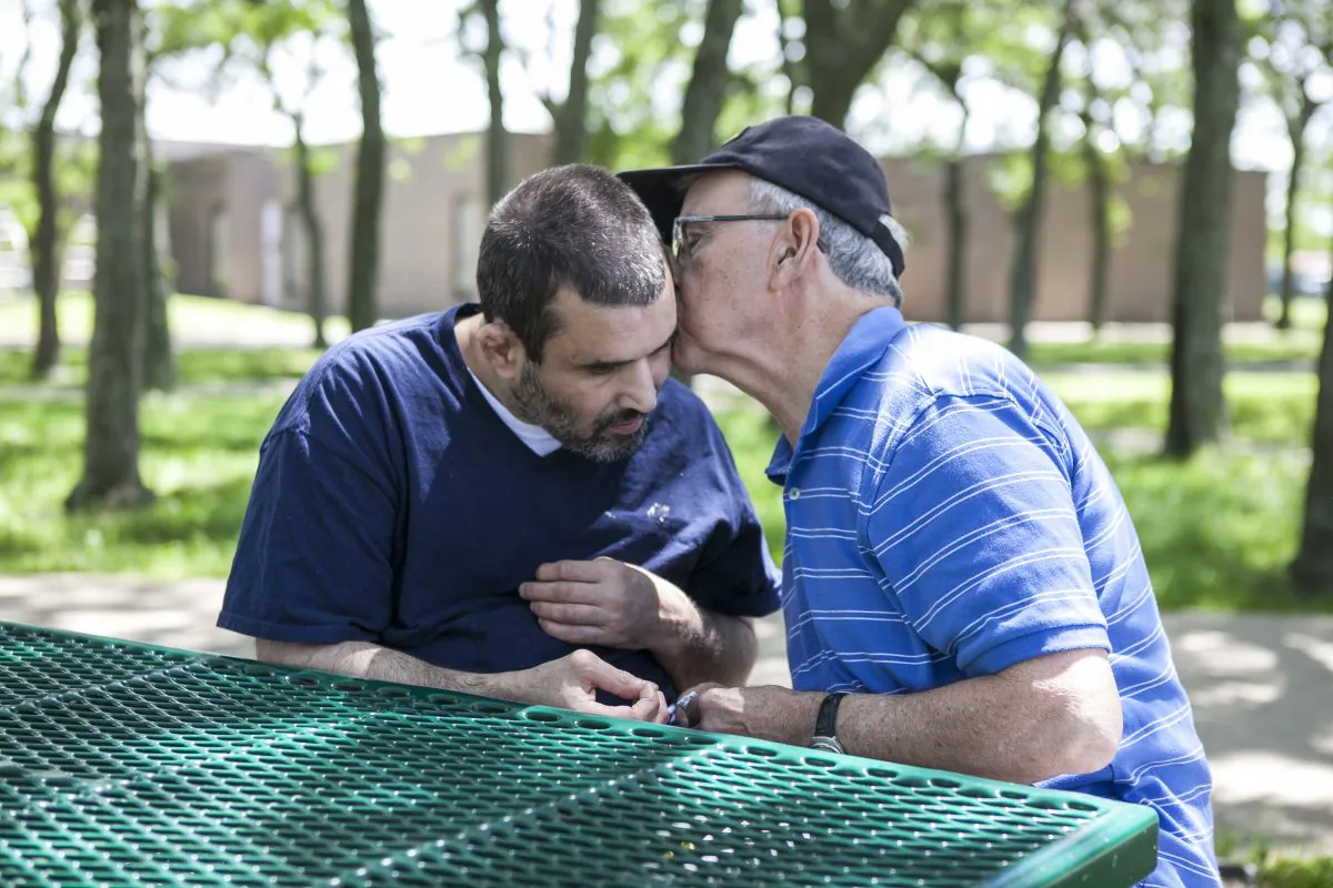 Anthony Cosentino and his son, John Cosentino, at the Brooklyn Developmental Center, June 20, 2014. The center is one of the two developmental centers in NYC that are slated to close under Governor Cuomo's initiative to transition adults with developmental disorders from institutions to group homes. Some fear group homes cannot adequately care for those who have severe disorders. (Samira Bouaou/Epoch Times)