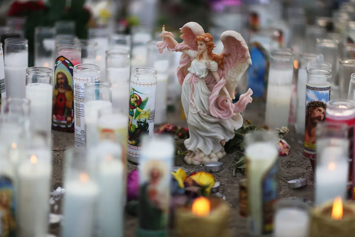An angel statue is seen among candles at a makeshift memorial near the Inland Regional Center in San Bernardino, Calif., on Dec. 6, 2015. (Joe Raedle/Getty Images)