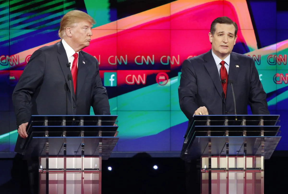 Ted Cruz, right, speaks as Donald Trump looks on during the CNN Republican presidential debate at the Venetian Hotel & Casino on Tuesday, Dec. 15, 2015, in Las Vegas. (AP Photo/John Locher)