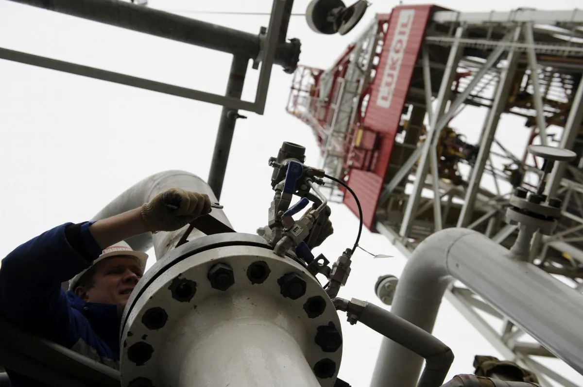 A worker tightens the bolts of a pipe on the Russian LUKoil ice-resistant fixed platform LSP-1, built at the Astrakhansky Korabel shipyard and intended to drill and operate wells and collect and pre-treat reservoir content at Korchagins oilfield in the Russian sector of the Caspian Sea some 180 kilometers (112 miles) outside Astrakhan. (Mikhail Mordasov/AFP/Getty Images)