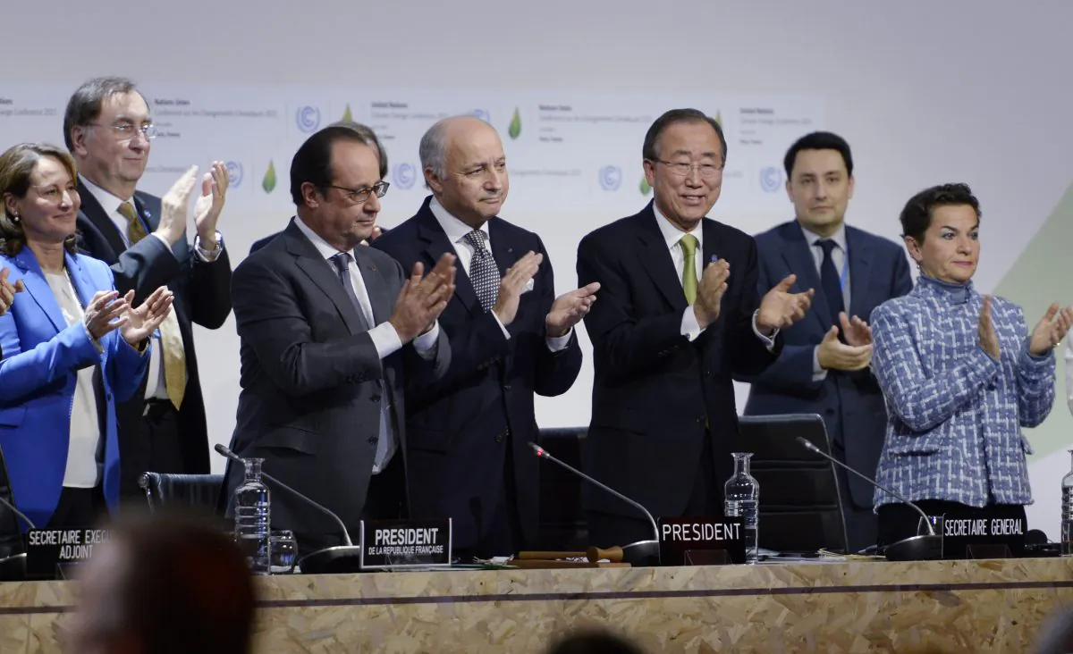 French Ecology Minister Segolene Royal (L), French President Francois Hollande (2ndL), French Foreign Minister Laurent Fabius (C) and United Nations Secretary General Ban Ki-moon (2ndR) applaud after a statement at the COP21 Climate Conference in Le Bourget, north of Paris, on Dec. 12, 2015.  (Miguel Medina/AFP/Getty Images)