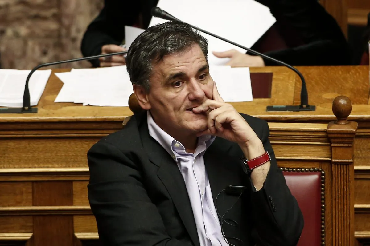Greece's Finance Minister Euclid Tsakalotos attends a parliamentary session ahead of a vote, in Athens, on Tuesday, Dec. 15, 2015. Lawmakers in Greece are set to sanction the right to sell bad business loans from local banks to overseas funds as part of a new austerity bill demanded by bailout lenders from the rest of the eurozone. (AP Photo/Yorgos Karahalis)