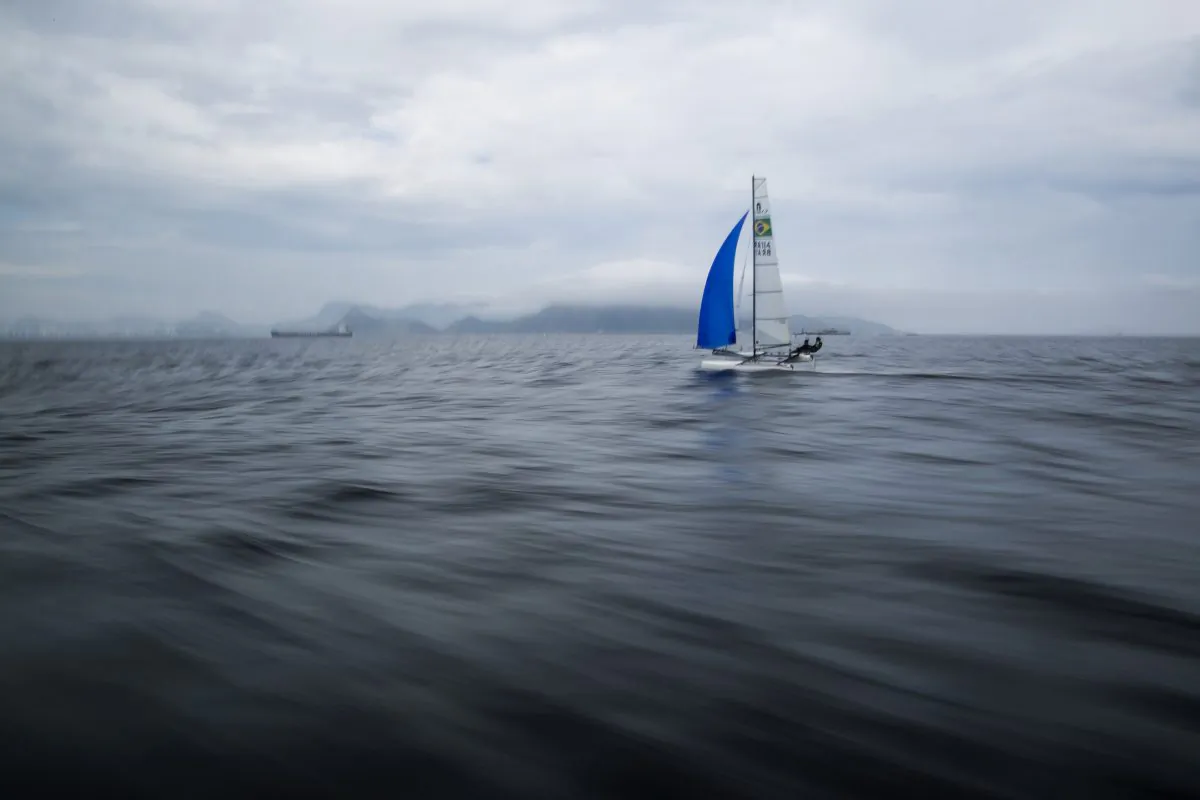 Brazilian athletes Samuel Albrecht and Isabel Swan practice in Guanabara Bay in Rio de Janeiro, Brazil, on Nov. 3, 2015. Since August, The Associated Press has expanded its testing to include offshore sampling sites inside sailing circuits in the bay and in the middle of the Rodrigo de Freitas Lagoon where rowing and canoeing lanes were located during recent test events. (AP Photo/Felipe Dana)
