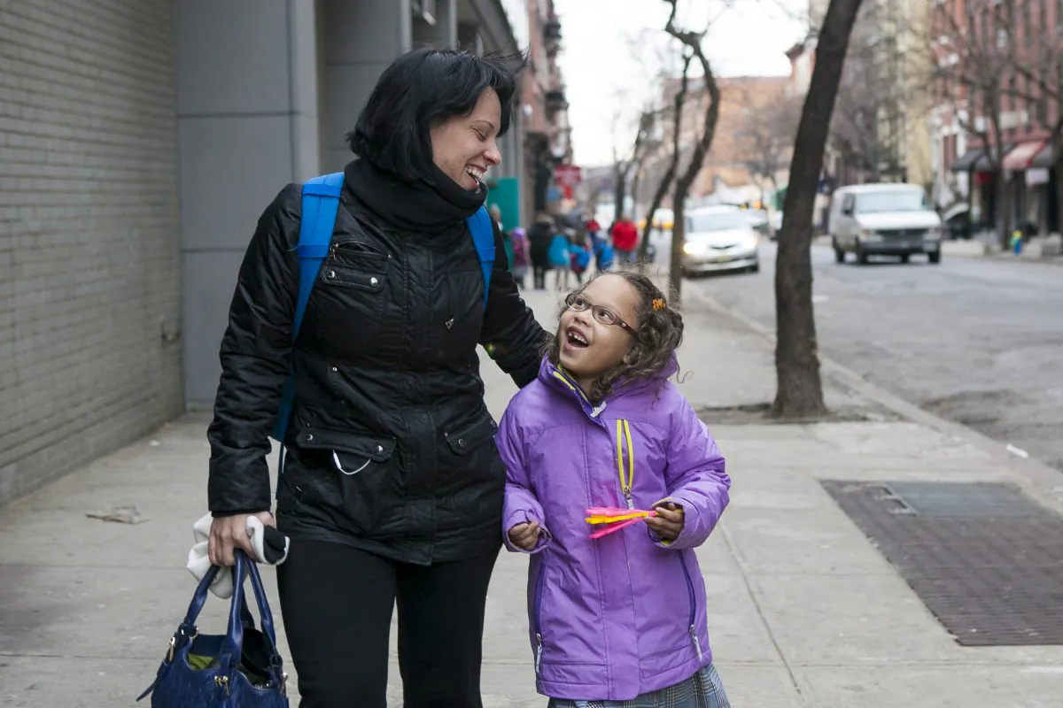 Jenny Pena walks her daughter to school at the Success Academy Hell's Kitchen in New York on March 17. (Samira Bouaou/Epoch Times)