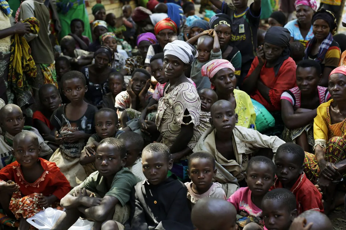 Refugees who fled Burundi's violence and political tension wait to board a U.N. ship at Kagunga on Lake Tanganyika, Tanzania, on May 23, 2015, to be taken to the port city of Kigoma. (AP Photo/Jerome Delay)