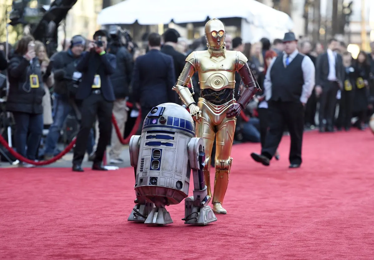 Film characters R2-D2 (L) and C-3PO arrive at the world premiere of "Star Wars: The Force Awakens" in Los Angeles on Dec. 14, 2015. (Jordan Strauss/Invision/AP)