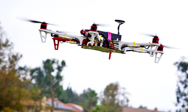 Engineers are developing software to predict and prevent collisions of unpiloted aircraft so that, within  milliseconds, a dozen drones delivering Christmas Eve packages will know precisely what maneuvers to take to ensure each enjoys a safe flight path down a crowded cul-de-sac. (Richard Unten/CC BY 2.0)