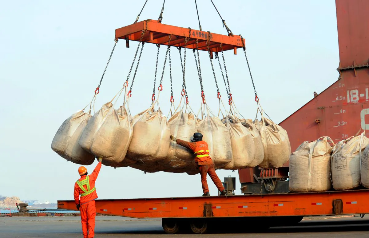 Workers unload goods from a ship at the port in Lianyungang, east China's Jiangsu province on February 12, 2014. (STR/AFP/Getty Images)