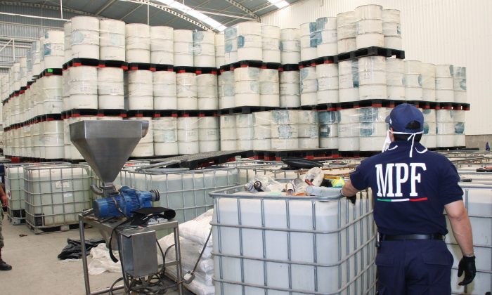 Police from the Federal Public Ministry examines drums of precursor chemicals for methamphetamine seized in Queretaro, Mexico, on June 20, 2011. Mexican drug cartels are flooding U.S. cities with cheap, extraordinarily pure methamphetamine made in factory-like "super labs." (Attorney General's office/AP Photo)