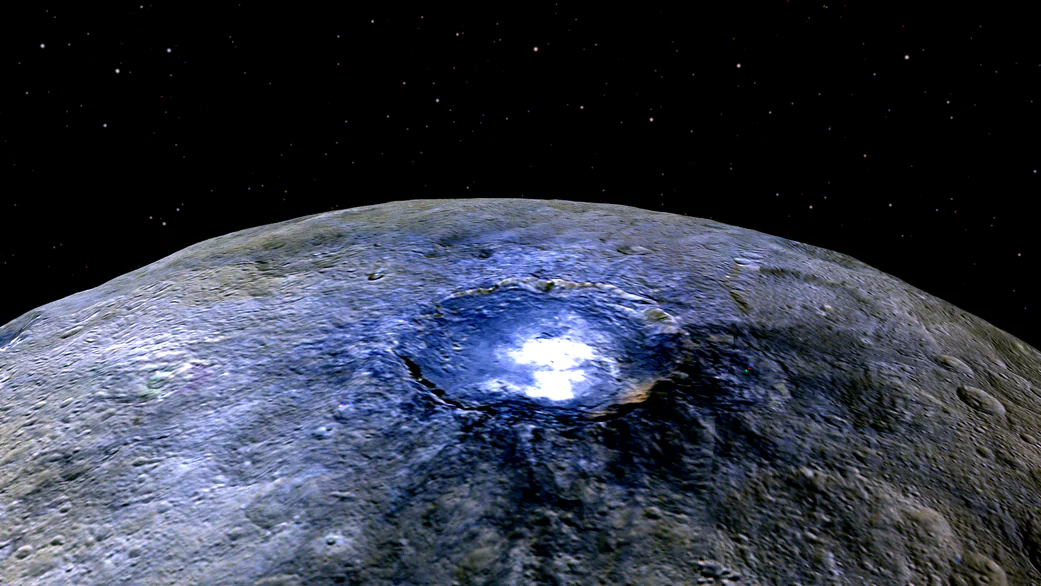 "Ceres itself is very dark. It's one of the darkest asteroids visited," says Carle Pieters. "But these spots were much, much brighter than everything else on the surface." This image of bright spots in the Occatur Crater was taken by the Dawn spacecraft from a distance of about 2,700 miles (4,400 kilometers). See more NASA images of Ceres. (Credit: NASA/JPL-Caltech/UCLA/MPS/DLR/IDA)