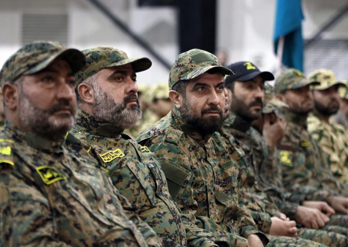 Hezbollah terrorists listen to Hezbollah leader Sheik Hassan Nasrallah, as he speaks via a video link during a rally to mark the Hezbollah martyr day, in the southern suburb of Beirut, Lebanon, on Nov. 11, 2015. (AP Photo/Bilal Hussein)