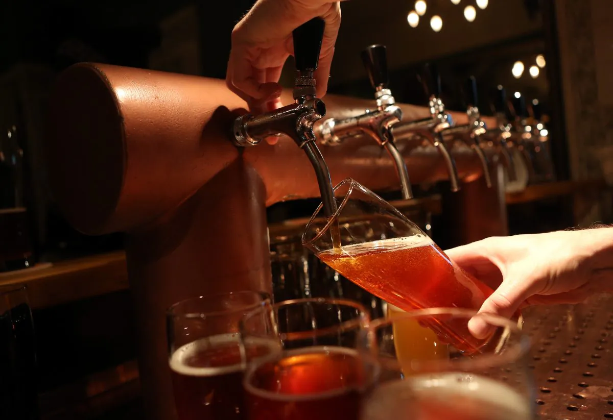 A bartender at Hops & Barley brewpub pours a pint of beer on Nov. 12, 2013, in Berlin, Germany. In a country known for centuries for its beer, several microbreweries have opened within the past year that are not only bending traditional rules on the types of ingredients used, opting for American-style hops such as Amarillo and Cascade instead of German ones, but also moving beyond the official legal doctrine, known as the Reinheitsgebot, or 'German Beer Purity Law,' which stated that water, barley and hops were the only ingredients allowed in the production of the beverage. While the law has since been expanded, it continues to be referenced on beer bottles for marketing purposes. (Adam Berry/Getty Images)