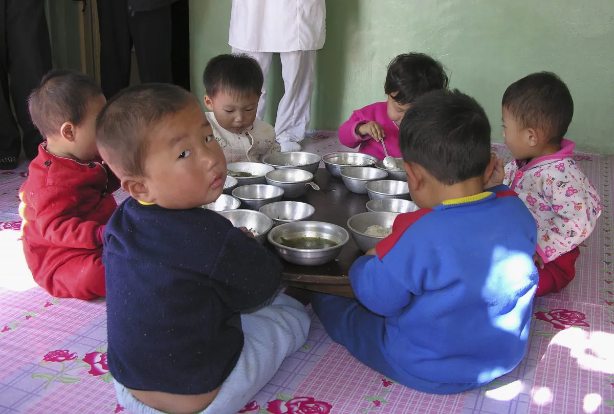 Children attend a government run nursery with special food provided by the World Food Program in Pyongyang, North Korea, on Oct. 18, 2005. According to the WFP website, "Child malnutrition for children under the age of seven [in N. Korea] has improved over the years but is still high. In the latest survey, carried out in 2002, 40% of the children were stunted, 20% were underweight and 8% were wasted. The stunting rate is regarded as a severe public health problem (WHO standards)." (Gerald Bourke/WFP via Getty Images)