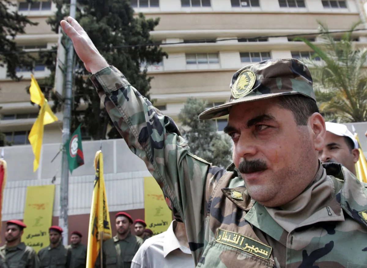 Released prisoner Samir Kantar salutes people as he arrives to pay respect at the grave of slain top Hezbollah military commander Imad Mughniyeh, south of Beirut, Lebanon, on July 17, 2008. Kantar, the longest-held Lebanese prisoner in Israel, has been killed in an Israeli airstrike that targeted a residential building near the Syrian capital, the Lebanese Shiite Hezbollah group said Sunday, Dec. 20, 2015. (AP Photo/Darko Bandic)