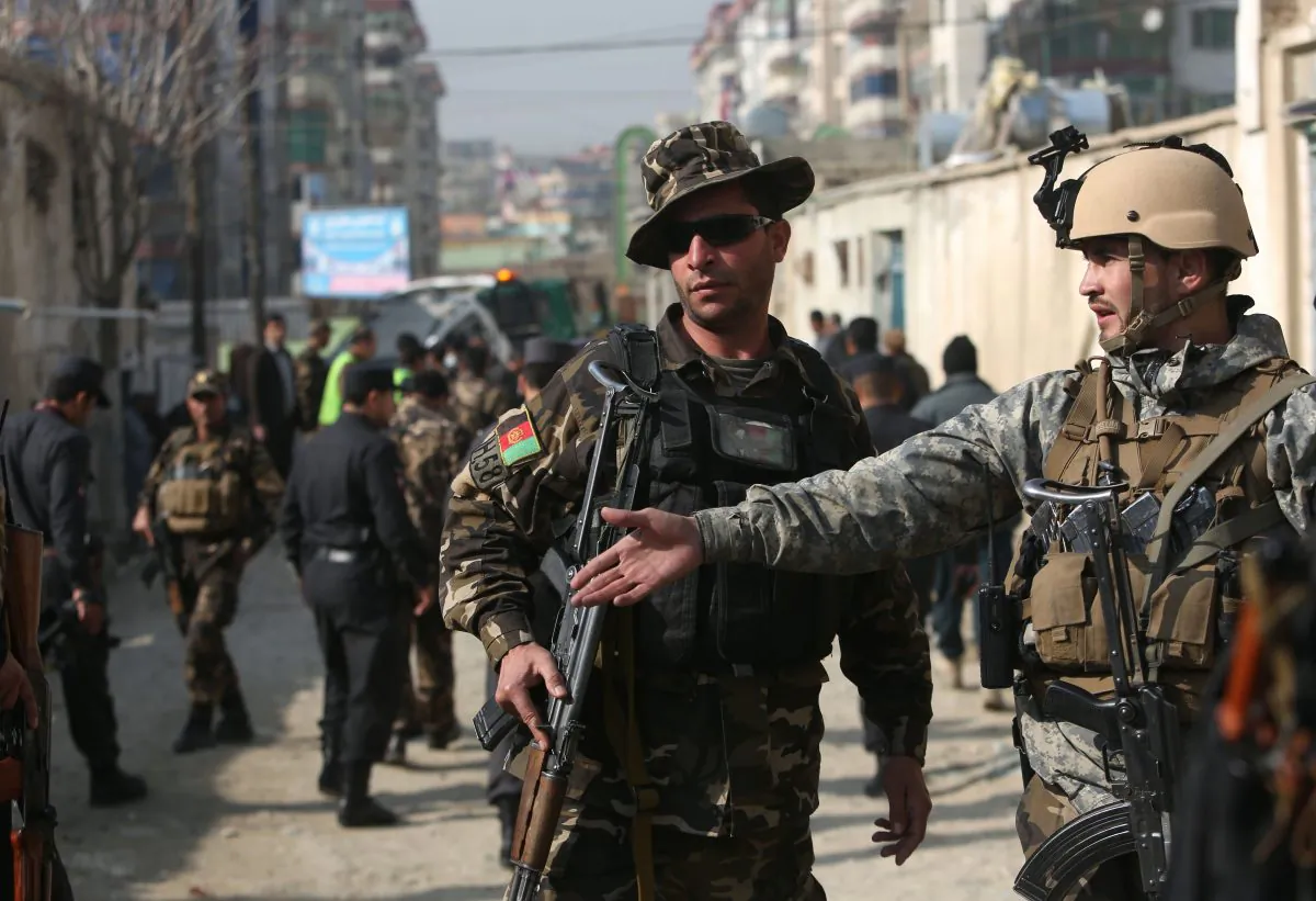 Afghan security forces inspect the site of a suicide attack in Kabul, Afghanistan, on Nov. 28, 2015. (AP Photo/Rahmat Gul)