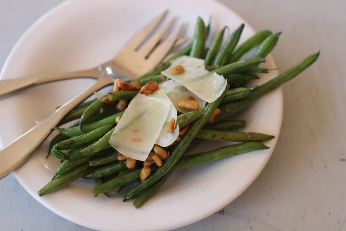 This Nov. 9, 2015, photo, shows green beans with anchovies, Parmesan and pine nuts in Concord, N.H. This recipe is by Melissa D'Arabian. (AP Photo/Matthew Mead)