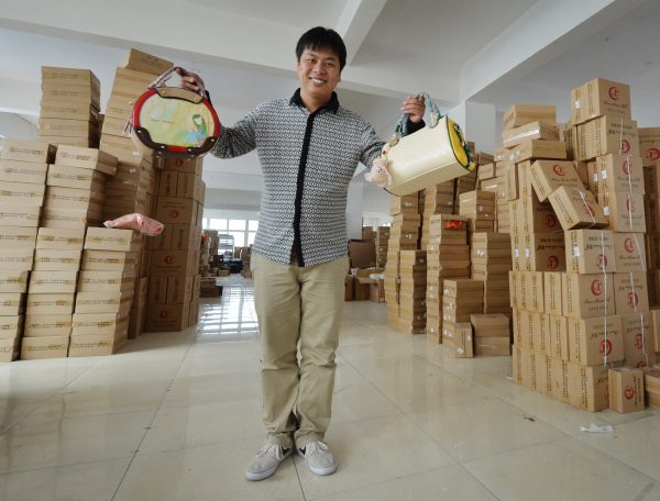 Owner Huang Jianqiao at his handbag factory which sells his merchandise through the Chinese Internet e-commerce site Taobao in Baigou, Hebei Province, April 24, 2014. In 2015, some financial companies started to use Taobao to dispose of bad loans. (Mark Ralston/AFP/Getty Images)