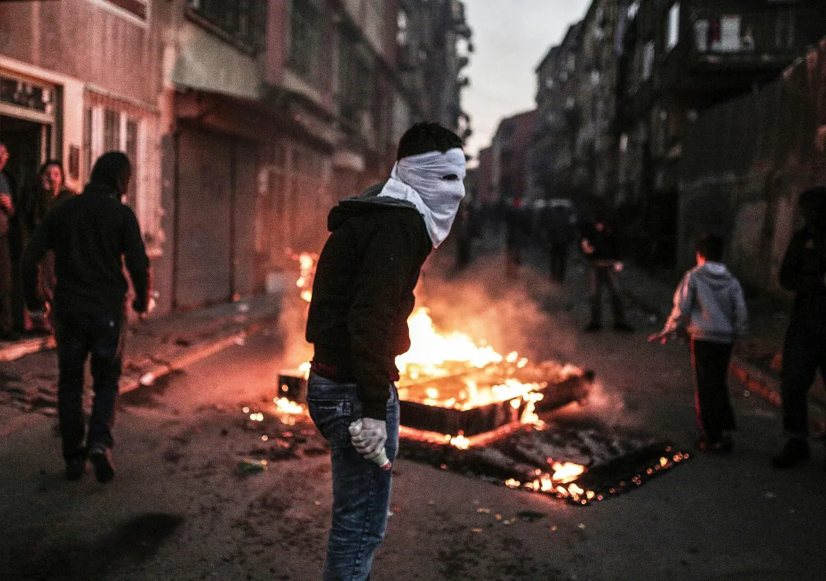 A masked protester holds a petrol bomb during clashes with Turkish police using water cannons and tear gas to disperse a demonstration in Istanbul, protesting security operations against Kurdish rebels in southeastern Turkey, on Dec. 20, 2015. The number of Kurdish rebels killed in a massive Turkish military offensive in the restive southeast has jumped to 115, as the operation entered its fifth day. The government has imposed curfews in the mainly Kurdish towns of Cizre and Silopi as security forces battle militants linked to the Kurdistan Workers' Party (PKK). (Cagdas Erdogan/AFP/Getty Images)