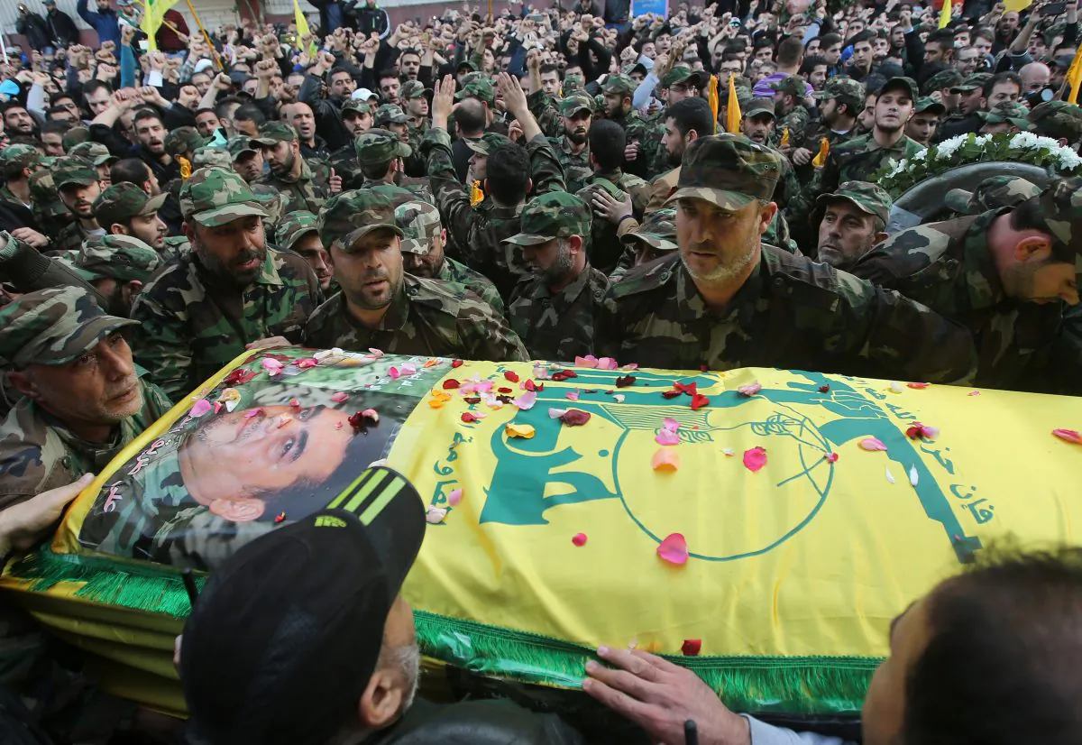 Fighters gather around the coffin of Hezbollah high-profile militant Samir Kantar during his funeral procession, in the southern suburb of Beirut, Lebanon, on Dec. 21, 2015. (AP Photo/Hussein Malla)