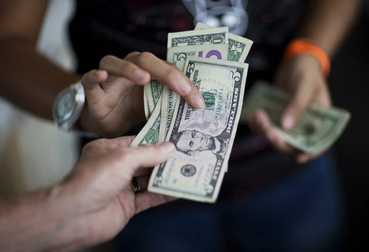 A customer pays for goods while shopping at the Atlanta Farmers Market in Atlanta in a file photo. (David Goldman/AP Photo)