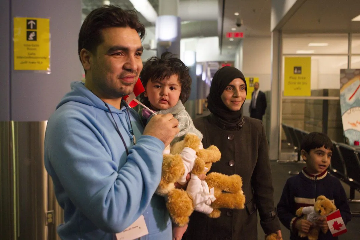 A family of Syrian refugees arrives at the Welcome Centre at Toronto's Pearson Airport on Dec. 18, 2015. Social media is playing a key role in community organizing as 25,000 refugees arrive in Canada over the next few months. (The Canadian Press/Chris Young)