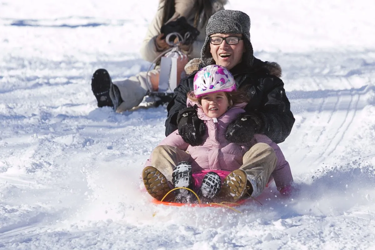 People enjoy sledding in the East Side of Central Park on Jan. 3, 2014. (Samira Bouaou/Epoch Times)