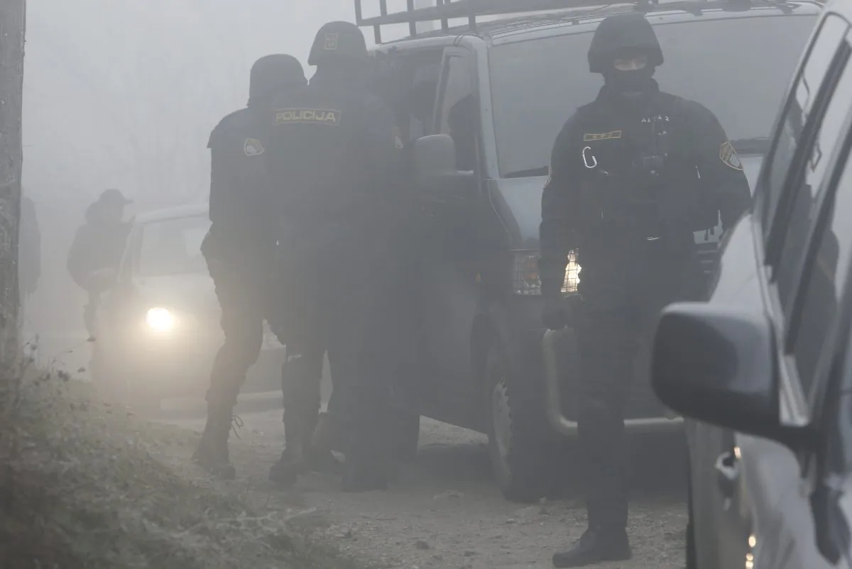Bosnian policemen secure an urban area in a Sarajevo suburb during a raid 
targeting suspected terrorists in Sarajevo, Bosnia, on Dec. 22, 2015. 
(Amel Emric/AP Photo)