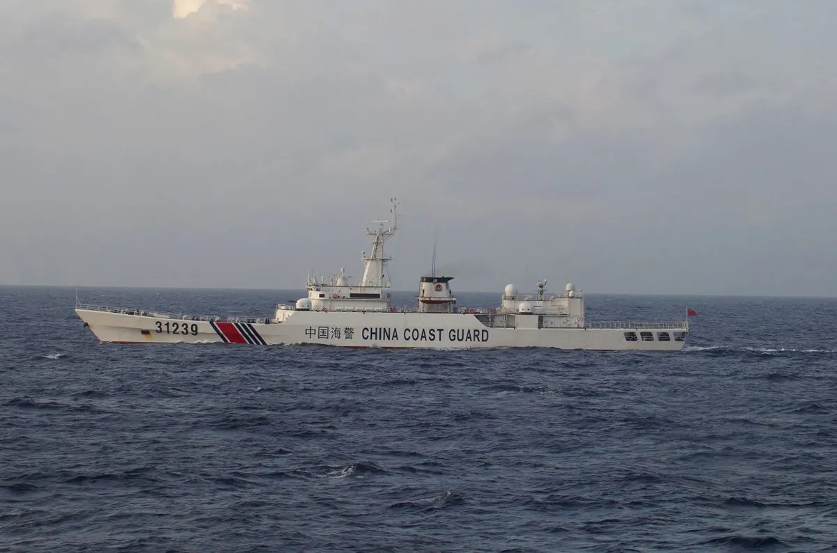 In this photo provided by Japan Coast Guard, an armed Chinese coast guard ship sails in the water near islands, known as the Senkaku in Japanese and the Diaoyu in Chinese, on Dec. 22, 2015. (Japan Coast Guard via AP)