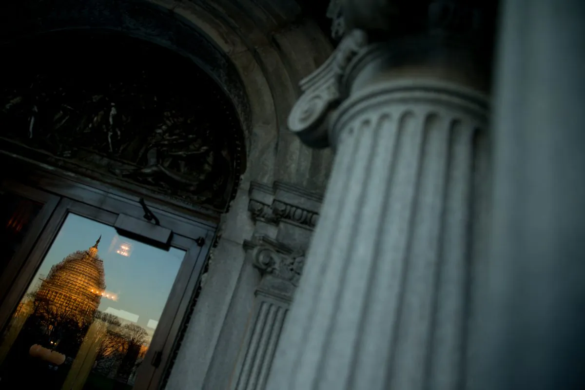 The Capitol Dome seen in reflection from a door to the Library of Congress at sunrise in Washington, D.C., on Dec. 19, 2015. (AP Photo/Andrew Harnik)