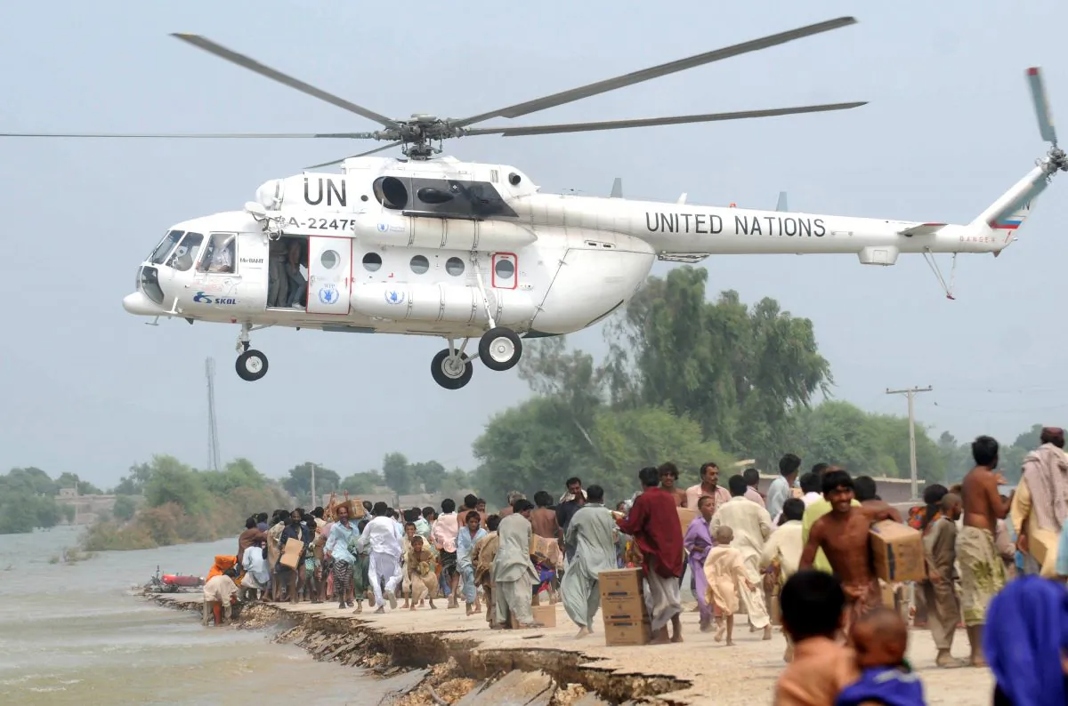 An U.N. helicopter drops relief goods to Pakistanis displaced by floods on higher ground in the flood-hit Chandan Village, Dadu District, on Sept. 10, 2010. (Rizwan Tabassum/AFP/Getty Images)