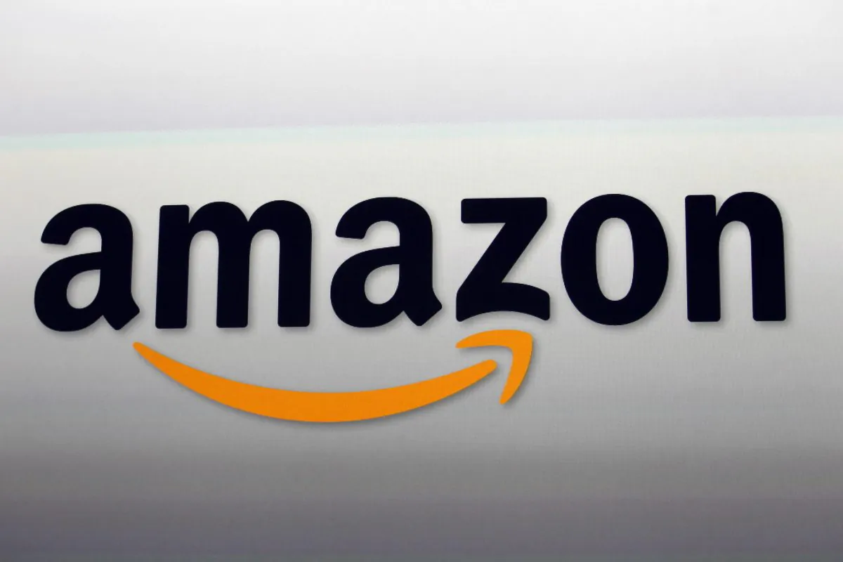 An Amazon logo at the introduction of the new Amazon Kindle Fire HD and Kindle Paperwhite personal devices, in Santa Monica, Calif., on Sept. 6, 2012. E-commerce giant Amazon celebrated its 20th anniversary with results that sent investors into a buying frenzy. Amazon was the second biggest gainer in the S&P 500 for the year, up 115 percent through Wednesday, Dec. 23, 2015. (AP Photo/Reed Saxon)