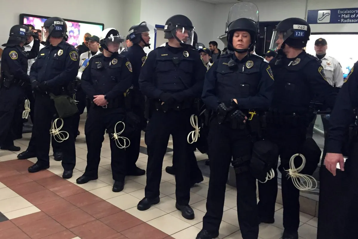 Law enforcement on the ground level tranport area at the Mall of America. A large protest that started at the Mall of America quickly migrated Wednesday, Dec. 23, 2015, to Minneapolis-St. Paul International Airport, where demonstrators blocked roads and caused significant traffic delays. (Leila Navidi/Star Tribune via AP)