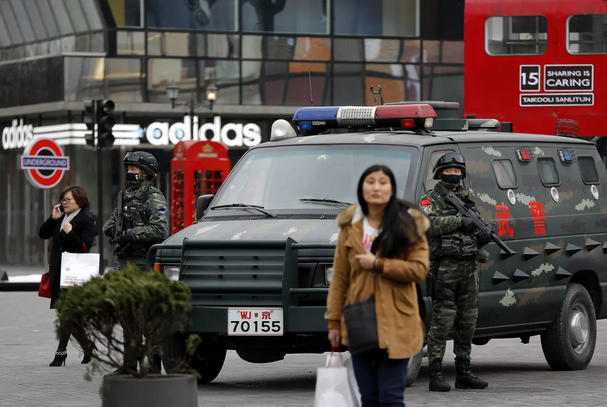 Armed Chinese paramilitary policemen stand guard in the capital city's popular shopping and nightlife area of Sanlitun in Beijing on Dec. 27, 2015. (AP Photo/Andy Wong)