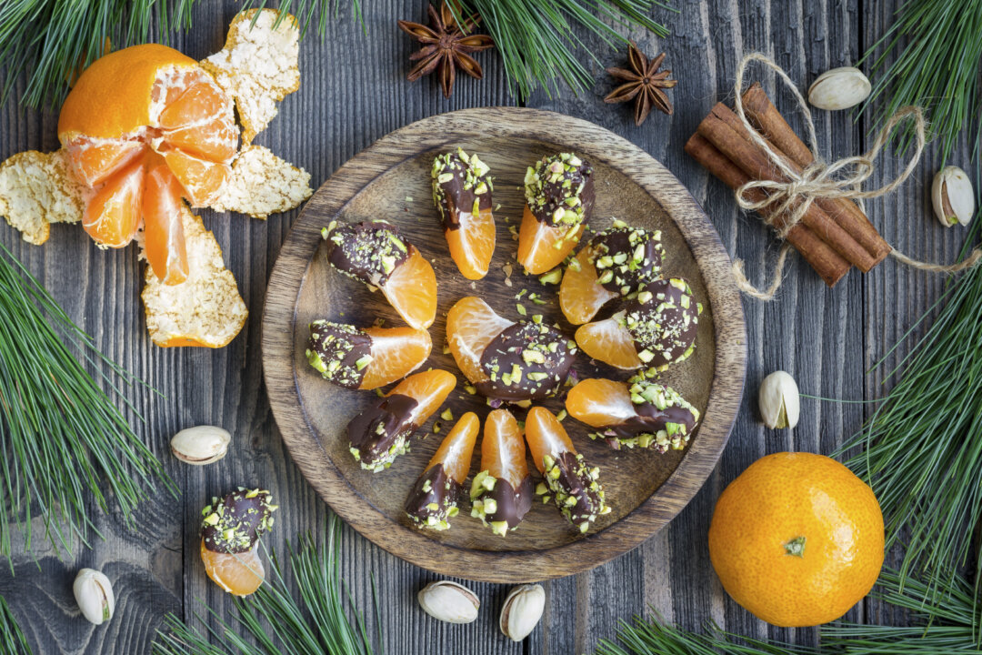 Mandarins covered with chocolate and pistachio ( iuliia_n/iStock)
