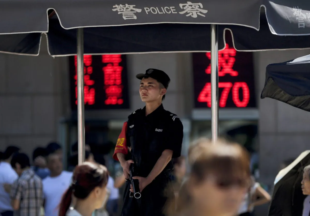 An armed policeman at a police booth at a crowded railway station in Beijing, China, on Sept. 3, 2014. Beijings tight controls and monopoly on the narrative make it difficult to independently assess if the lethal action has been justified. And Chinese authorities prevent most reporting by foreign journalists inside Xinjiang, making it nearly impossible to confirm the state media numbers. (AP Photo/Andy Wong)