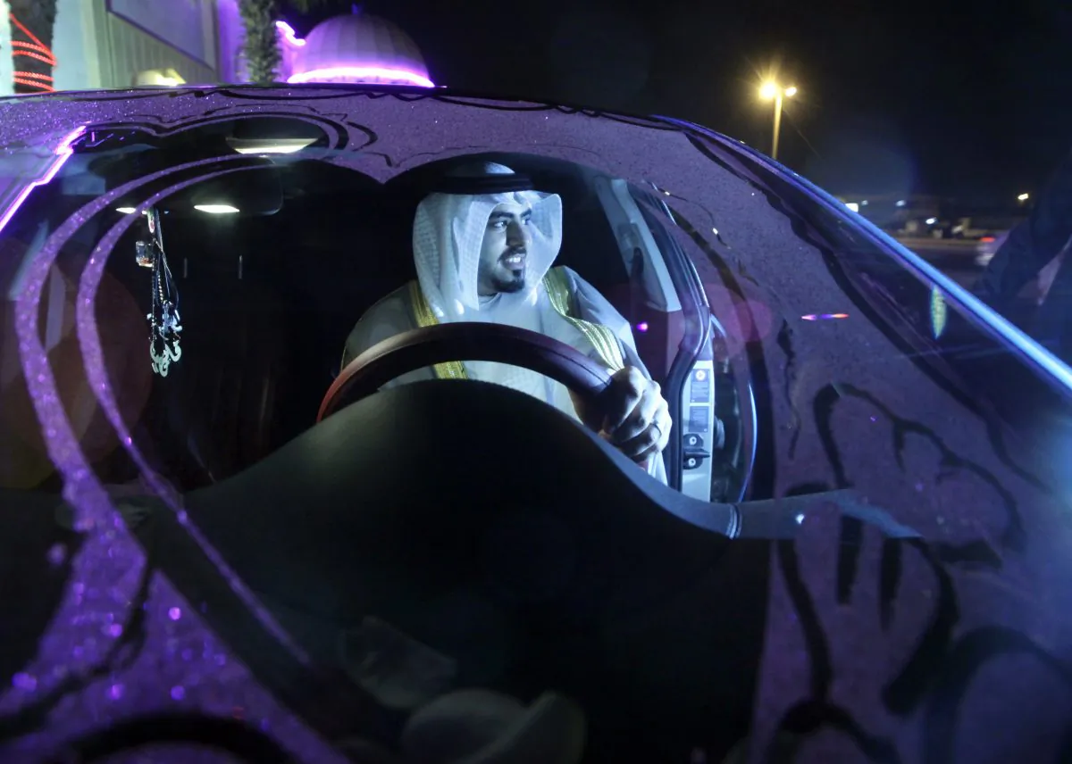 Saudi groom Hisham Saleh Edris drives his decorated car as he arrives alone at the men's section of the wedding hall in Jiddah, Saudi Arabia, on Sept. 8, 2015. (AP Photo/Amr Nabil)