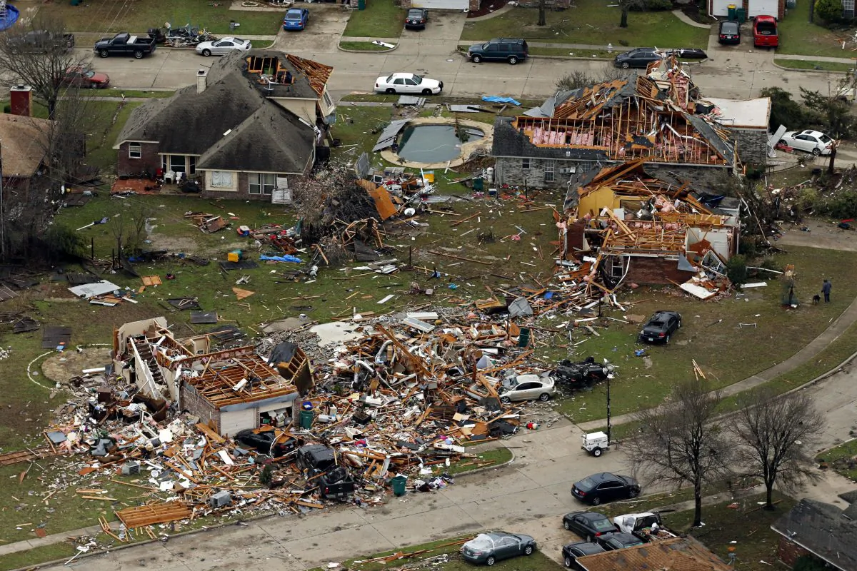 This aerial photo shows damage after a tornado ripped through the area in Glenn Heights, Texas, on Dec. 28, 2015. Residents surveyed the destruction from deadly tornadoes in North Texas as the same storm system brought winter woes to the Midwest on Monday, amplifying flooding that's blamed for more than a dozen deaths and prompting hundreds of flight cancellations. At least 11 people died and dozens were injured in the tornadoes that swept through the Dallas area Saturday and caused substantial damage. (G.J. McCarthy/The Dallas Morning News via AP)