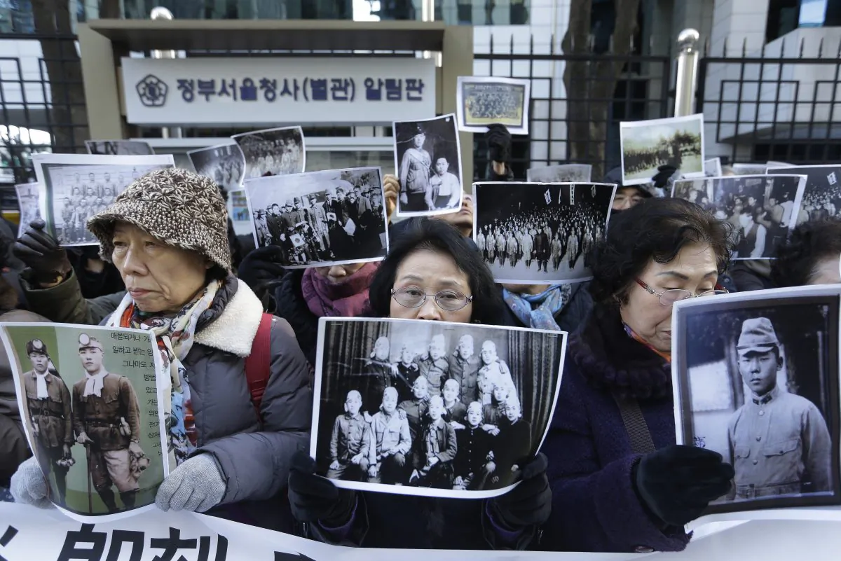 South Korean bereaved family members of victims of World War II stage a rally demanding full compensation and apology from Japanese government in front of Foreign Ministry in Seoul, South Korea, on Dec. 28, 2015. (AP Photo/Ahn Young-joon)