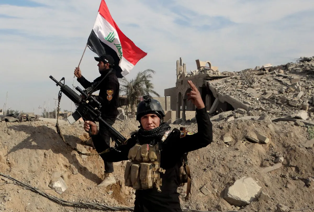 Iraqi security forces raise an Iraqi flag near the provincial council building in central Ramadi, 70 miles west of Baghdad on Dec. 27, 2015. (AP Photo/Osama Sami)