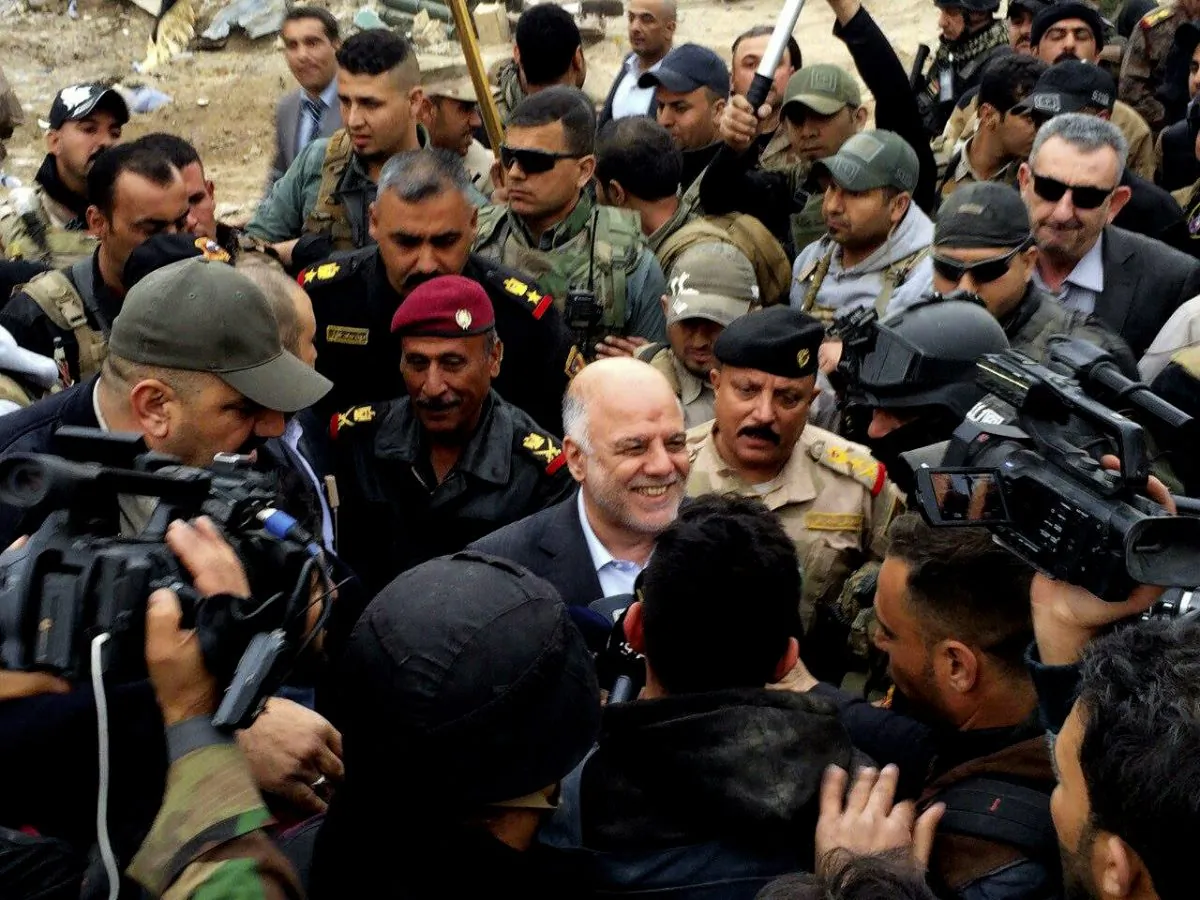 Iraqi Prime Minister Haider al-Abadi, center, smiles as he tours the city of Ramadi after it was retaken by the security forces in Ramadi, 70 miles (115 kilometers) west of Baghdad, Iraq, Tuesday, Dec. 29, 2015. (AP Photo)