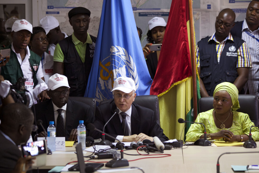 Mohamed Belhocine (C), a representative from World Health Organization (WHO), at a press briefing in Conakry City, Guinea, on Dec. 29, 2015. Guinea has been declared free from transmission of Ebola, WHO said Tuesday, marking a milestone for the West African country where the original Ebola chain of transmission began two years ago leading to the largest epidemic in history. (AP Photo/Youssouf Bah)