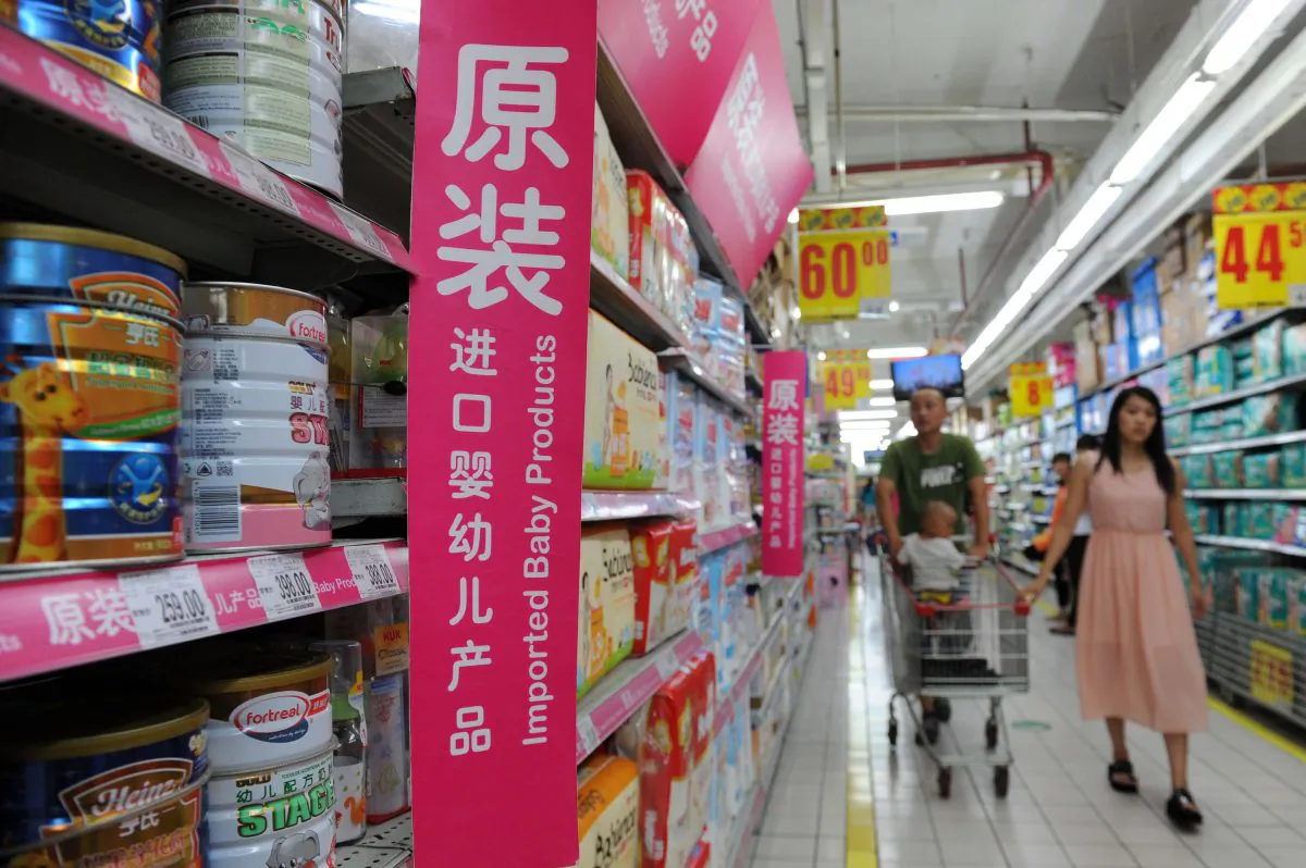 A family selecting baby formula in the imported baby products section of a supermarket in Beijing on Aug. 4, 2013. (STR/AFP/Getty Images)