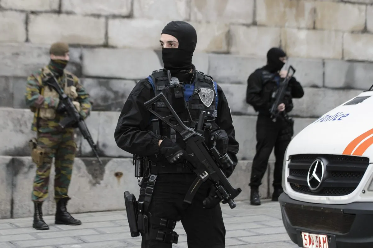 Belgian police officers and soldiers stand guard outside the Brussels Palace of Justice during the appearance before the council chamber of two individuals arrested in connection with the Nov. 13 attacks in Paris, in Brussels, on Nov. 20, 2015. (Nicolas Lambert/AFP/Getty Images)