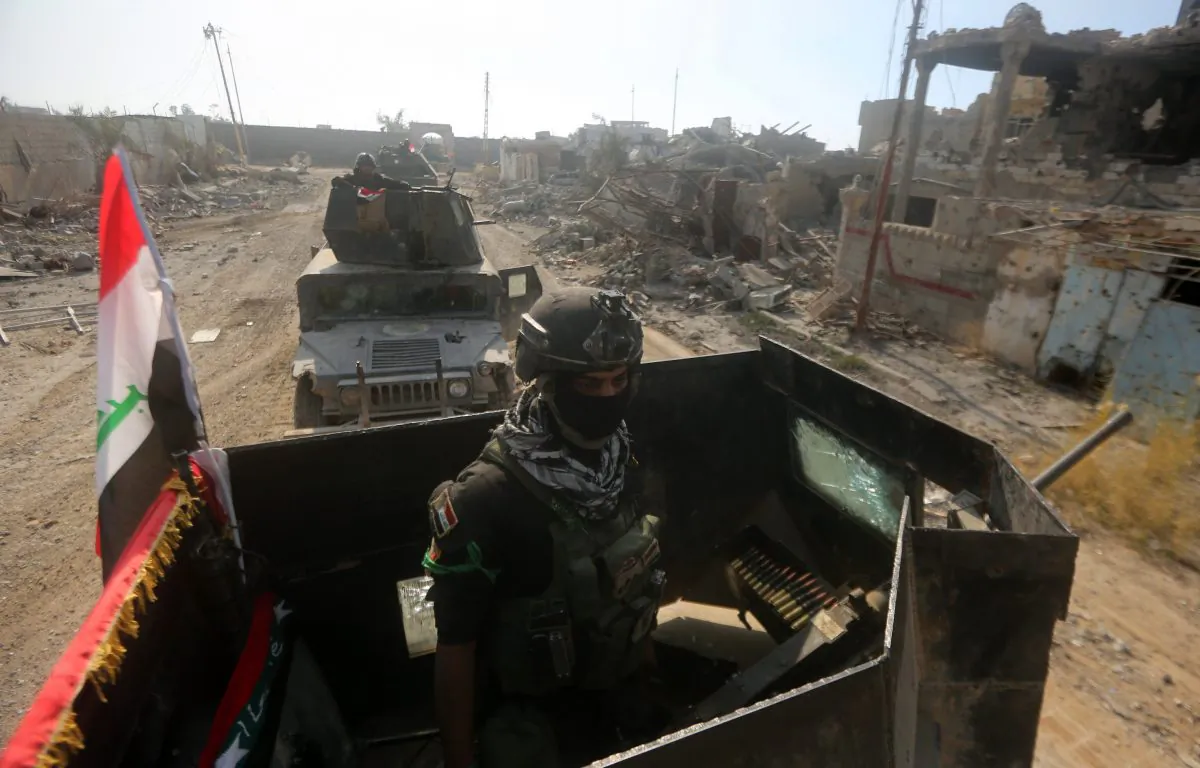 Members of Iraq's elite counterterrorism service ride their military vehicles amidst destroyed buildings in the city of Ramadi, the capital of Iraq's Anbar Province, about 110 kilometers (68 miles) west of Baghdad, after Iraqi forces recaptured it from the Islamic State (ISIS), on on Dec. 29, 2015. Iraq declared the city of Ramadi liberated from ISIS Monday and raised the national flag over its government complex after clinching a landmark victory against the jihadists. (Ahmad al-Rubaye/AFP/Getty Images)