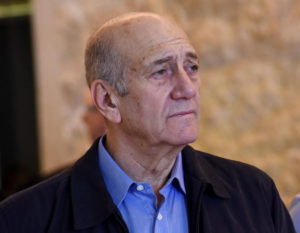 Former Israeli Prime Minister Ehud Olmert leaves the courtroom of the Supreme Court after the court ruled on his appeal in the Holyland corruption case in Jerusalem on Tuesday, Dec. 29, 2015. (Debbie Hill/Pool Photo via AP)
