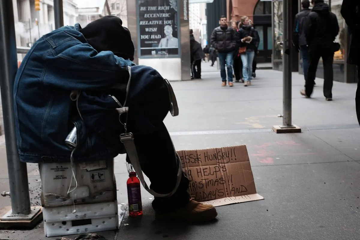 A homeless man rests on the street in New York City on Dec. 21, 2015. (Spencer Platt/Getty Images)