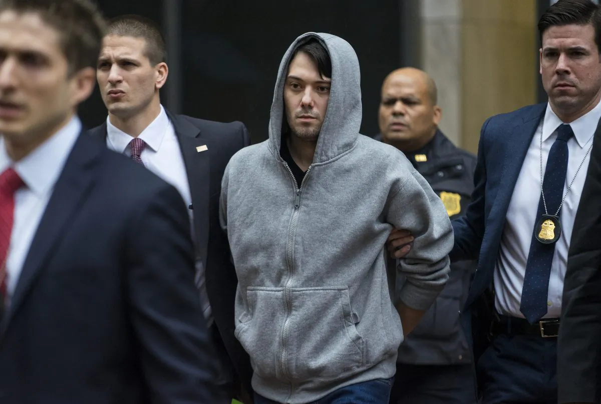 Former hedge fund manager Martin Shkreli is escorted by law enforcement agents in New York after being taken into custody following a securities probe on Dec. 17, 2015. KaloBios, the troubled drugmaker taken over by Shkreli in November, is seeking bankruptcy protection less than two weeks after his arrest on securities fraud. (AP Photo/Craig Ruttle)