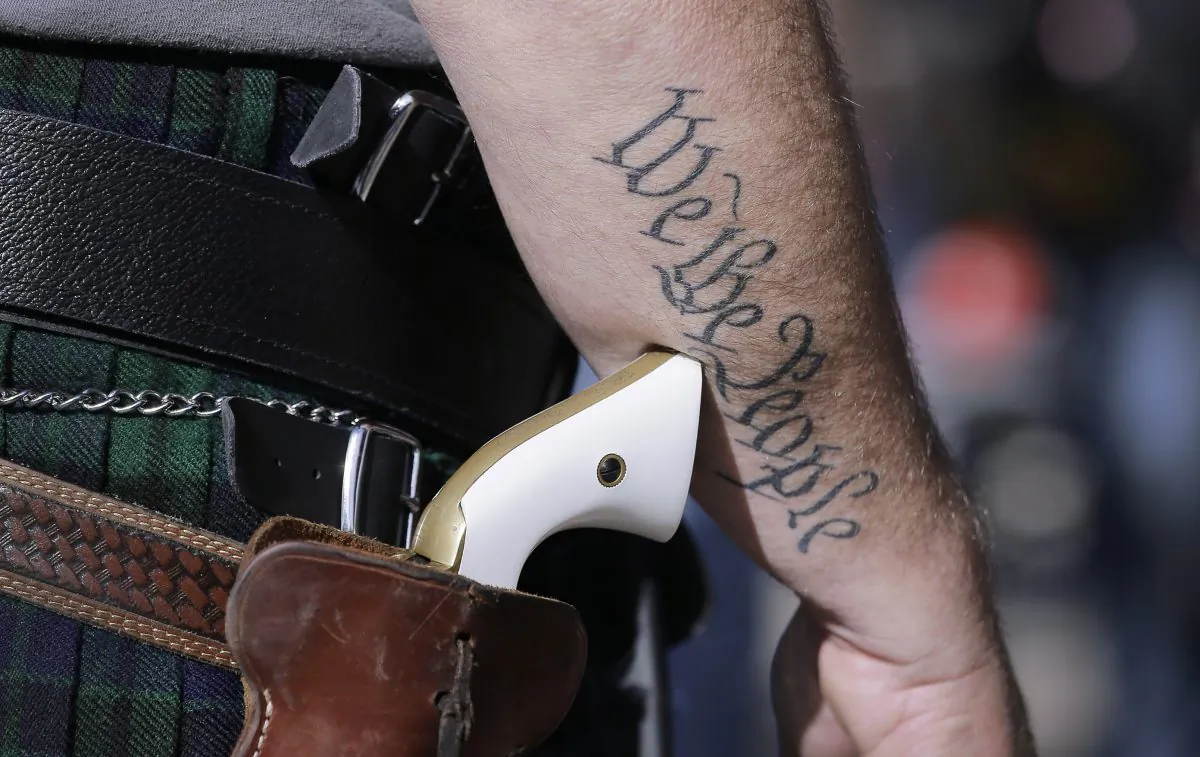 A supporter of open carry gun laws wears a pistol as he prepares for a rally in support of open carry gun laws at the Capitol in Austin, Texas, on Jan. 26, 2015. (Eric Gay/AP Photo)