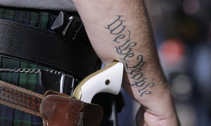 A supporter of open carry gun laws wears a pistol as he prepares for a rally in support of open carry gun laws at the Capitol in Austin, Texas, on Jan. 26, 2015. (Eric Gay/AP Photo)