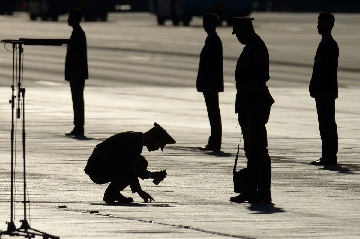 A Chinese soldier marks a spot on the ground before a military parade at Tiananmen Square in Beijing on Sept. 3, 2015. On Dec. 29, the 27th Army Group in Beijing, a unit notorious for partaking in the Tiananmen Square massacre on June 4, 1989, was disbanded, reorganized, and relocated to Shandong, a neighboring province. An army-wide reorganization is currently underway. (Wang Zhao/AFP/Getty Images)